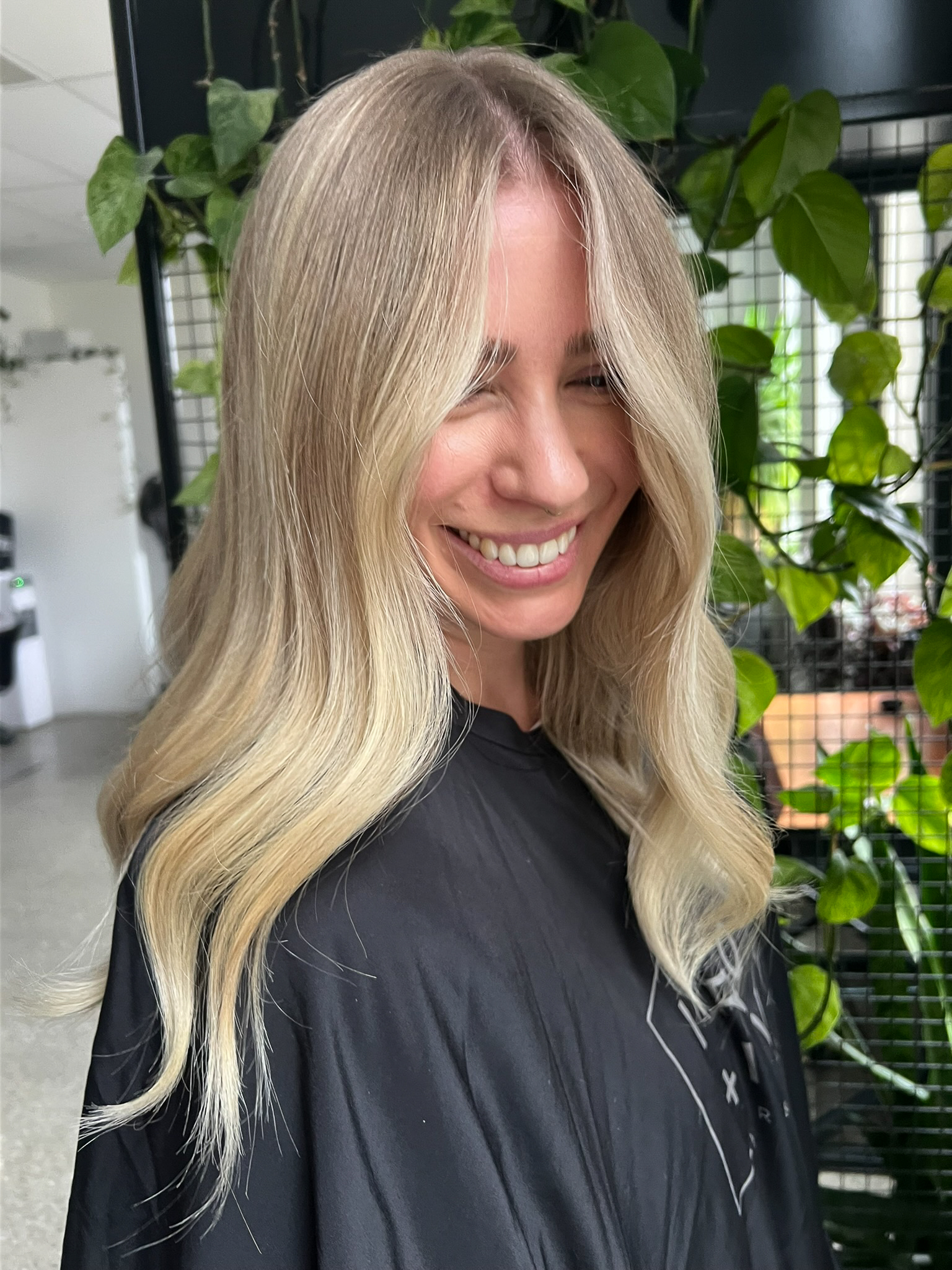 Hair extension specialist checking K-tip bonds at Iron + Ivy Hair Studio, Queenstown