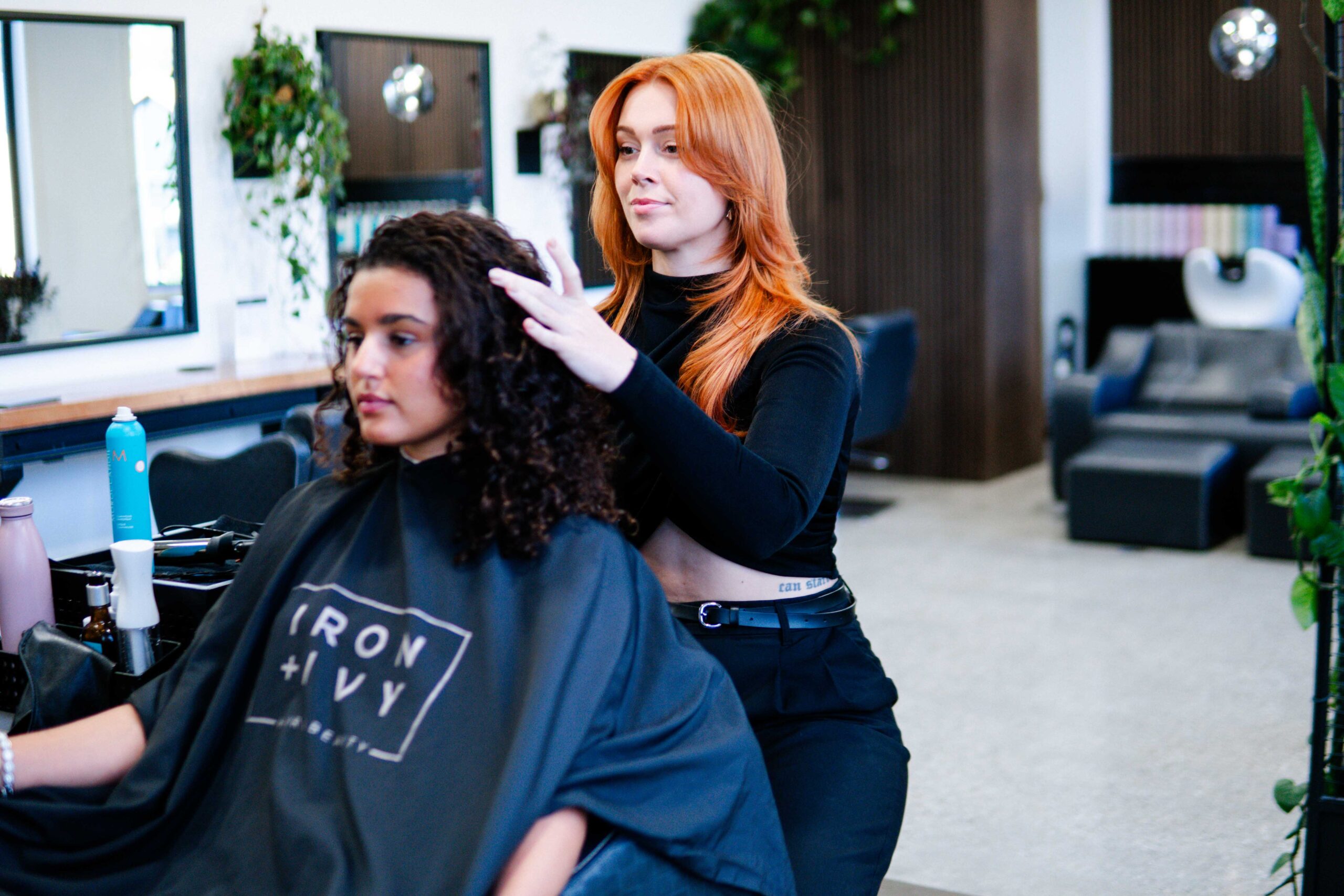 Iron And Ivy Queenstown Copper Stylist Assessing Curls Client 2025.Jpg