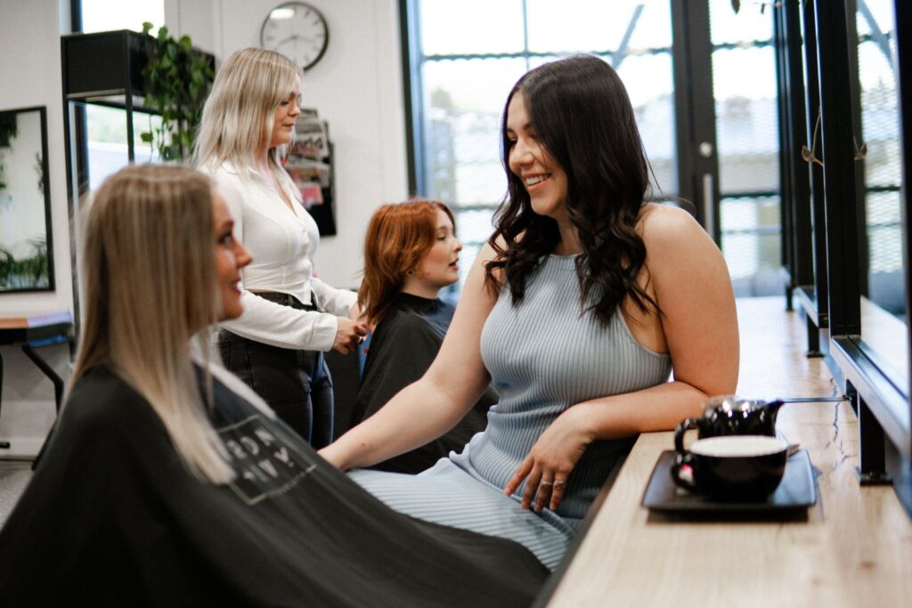 Iron + Ivy Hair Studio salon experience — clients and stylists at Five Mile Queenstown