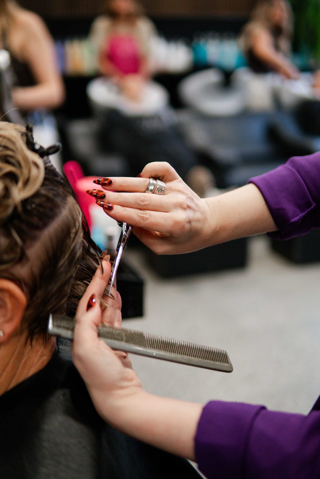 Applying colour with a tint brush during a foil service at Iron + Ivy Hair Studio, Queenstown