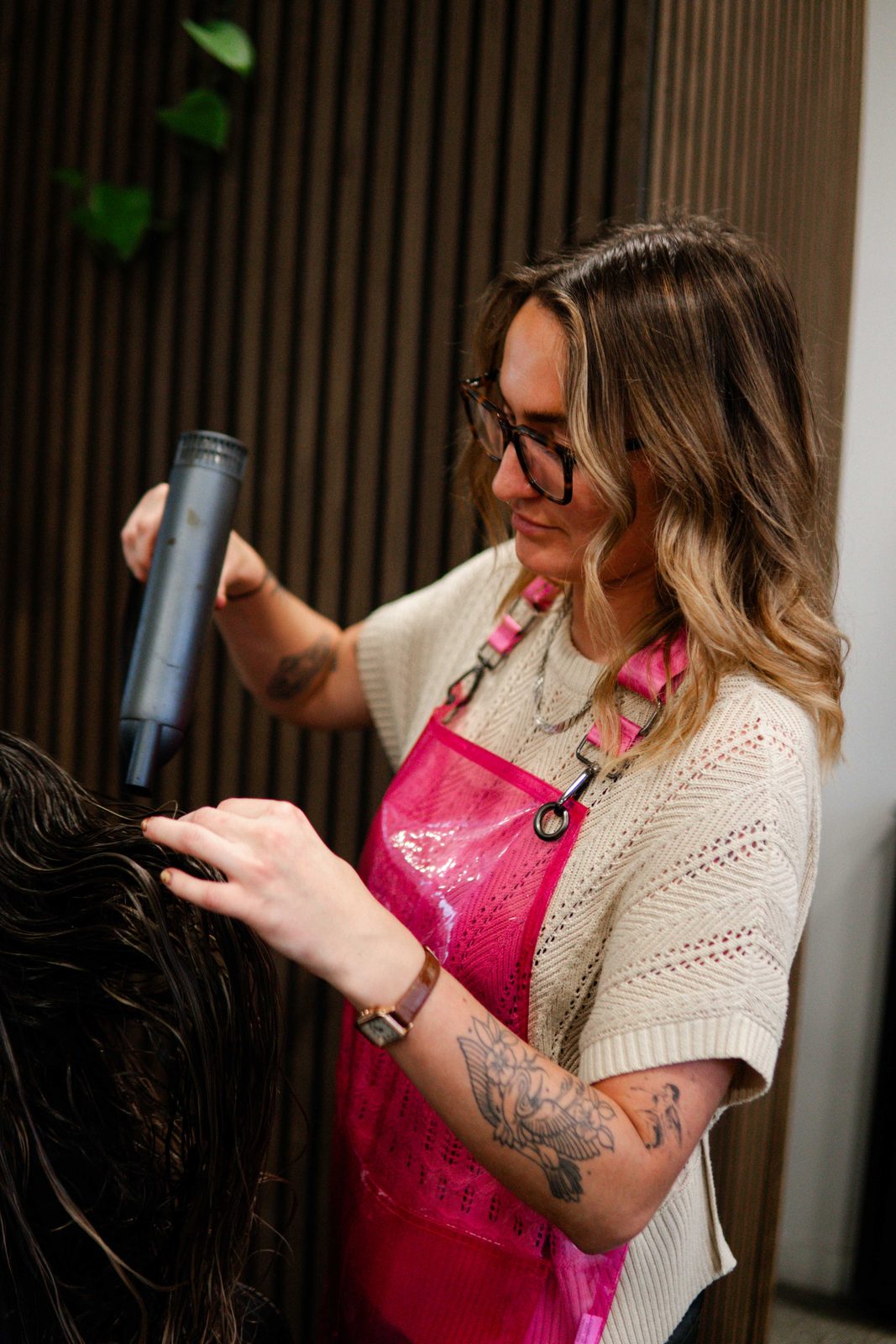 Smoothing hair with a flat iron at Iron + Ivy Hair Studio, Queenstown