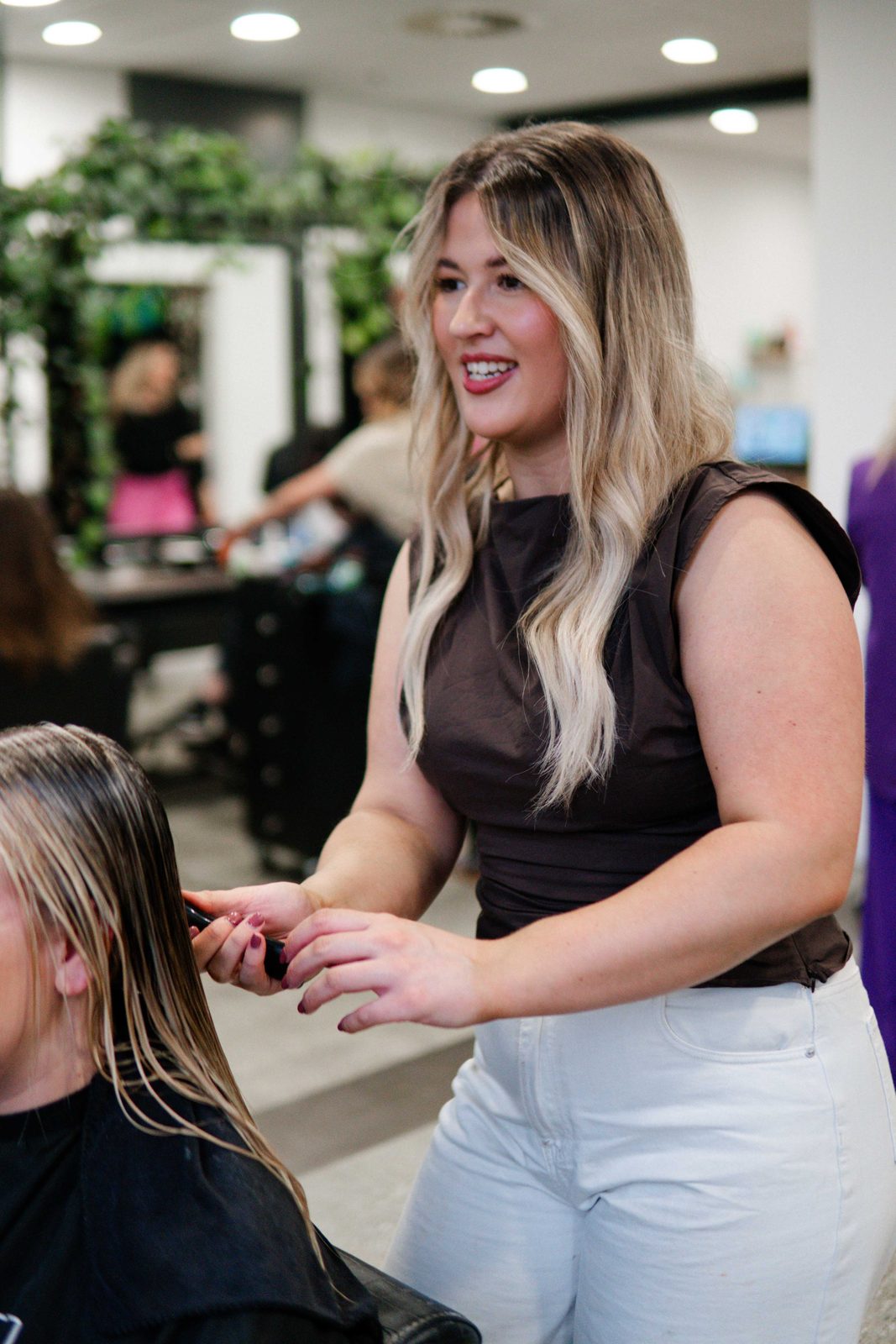 Stylist working through wet hair before styling at Iron + Ivy Hair Studio, Queenstown