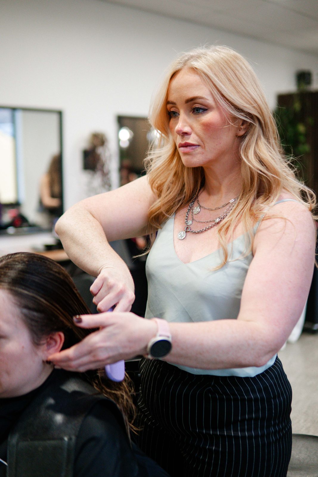 Stylist sectioning a client's hair at Iron + Ivy Hair Studio, Queenstown