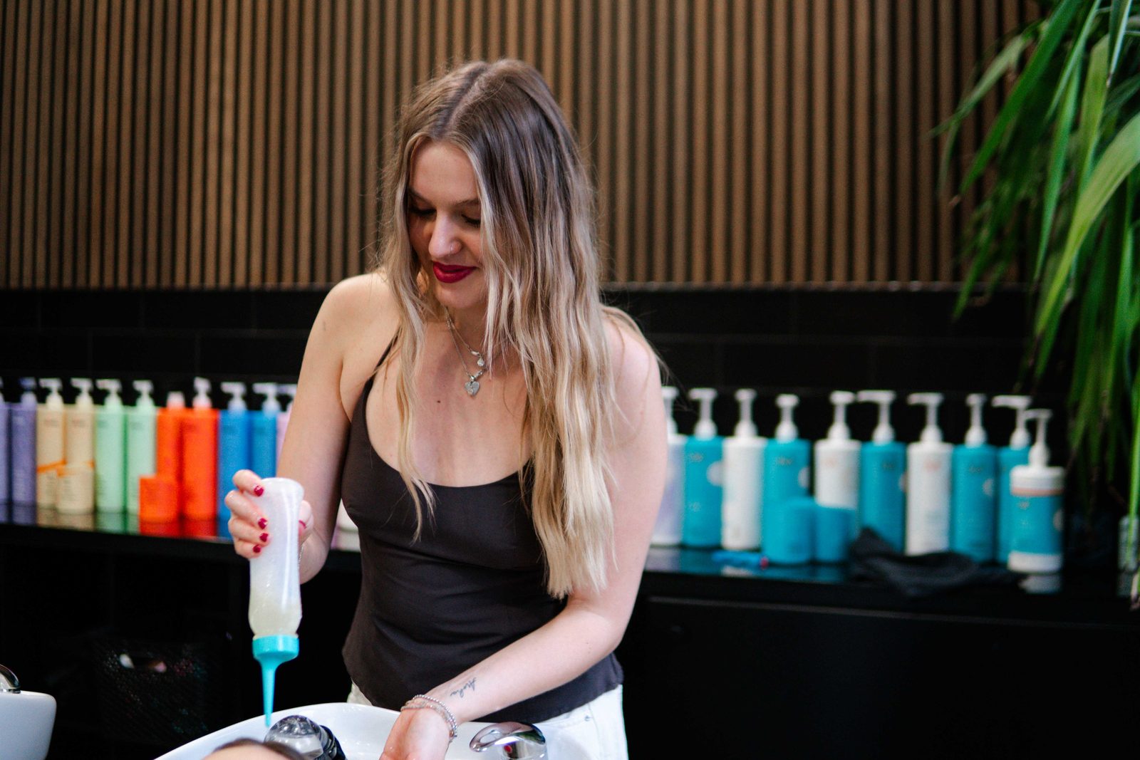 Applying a hair treatment at the backbar, Iron + Ivy Hair Studio Queenstown